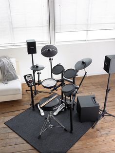 a set of musical instruments sits on a rug in front of a window