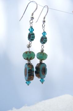 deep aqua flower earrings. Southwestern style blossoms made with table cut Czech glass beads,  Swarovski crystals and silver beads  Sterling silver ear wires. Nickel Free Czech Glass Flower Earrings, Turquoise Nickel-free Flower Earrings For Jewelry Making, Nickel-free Czech Glass Dangle Earrings, Blue Adjustable Czech Glass Beaded Earrings, Adjustable Blue Flower Earrings With Czech Glass, Unique Turquoise Czech Glass Earrings, Nickel-free Czech Glass Flower Dangle Earrings, Turquoise Czech Glass Dangling Beads Earrings, Turquoise Flower Earrings