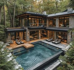 this is an image of a house in the woods with a swimming pool and hot tub