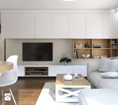 a living room filled with furniture and a flat screen tv mounted on a wall next to a dining table