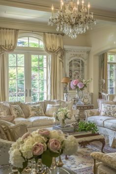 a living room filled with lots of furniture and flowers in vases on the coffee table