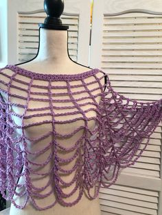 a mannequin with purple crochet on it's chest and back