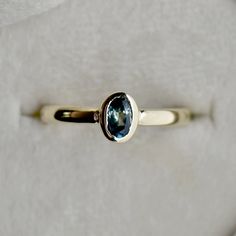 a gold ring with a blue stone on it