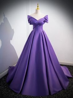 Captivating in its royal hue, could this gown be more enchanting? Crafted from luxurious satin in a rich purple, this ball gown is the epitome of elegance. The off-the-shoulder neckline is gracefully accented with a dramatic fold, while the bodice is sculpted to flatter the figure before cascading into a full, floor-length skirt that adds a regal air to every step. The sweeping train ensures a grand entrance, and the subtle sheen of the fabric captures the light, promising the wearer will be the Purple Wedding Dress The Bride, Two Piece Bridesmaid Dresses, Poofy Dresses, Polka Dot Wedding Dress, Flowy Prom Dresses, Wedding Dress Detachable Skirt, Puffy Prom Dresses, Country Bridesmaid Dresses, Purple Satin Dress