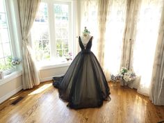 Black wedding dresses, gothic wedding dresses, black bridal gown, black wedding gown, princess ball gown, wedding ball gown, black gown,  Introducing our Black Princess Gown: A Gothic Twist on Timeless Elegance. For brides seeking a striking departure from tradition or a touch of Gothic allure, our Black Princess Gown is the perfect choice. Crafted with French-imported polka dot tulle and a silky champagne lining, this gown redefines bridal elegance. Elevate your wedding day with a unique and en Black Wedding Dresses Gothic, Wedding Dresses Gothic, Black Bridal Gown, Corset Dress Black, Tulle Dress Black, Black Prom Gown, Gothic Wedding Dresses, Black Plunge Dress, Wedding Gown Princess