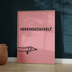 there is a pink poster with the words herengegedackelt on it next to a brown vase