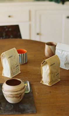 the table is set up with coffee cups and napkins