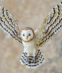 a beaded owl ornament hanging from a string