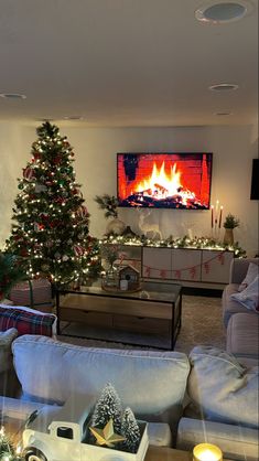 a living room filled with furniture and a christmas tree in front of a flat screen tv