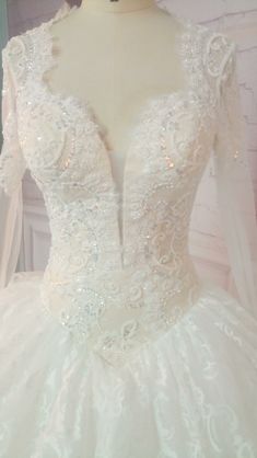 a white wedding dress is displayed on a mannequin