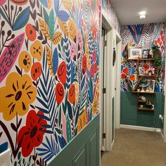 the hallway is decorated with colorful wallpaper and floral designs on it's walls