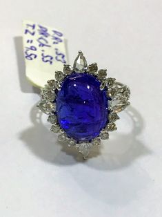 This tanzanite cabochon promise ring or anniversary ring is crafted in solid 18k white gold. The timeless and classic design of this beautiful ring will make your engagement or wedding unforgettable. SETTING :- Gross Weight: 4.054 grams Metal: 18K White Gold (Customisable Also in Yellow Gold - No Extra Charge) Ring Size: 6 (Can be customisable) MAIN STONE :- Gem Type: Natural Tanzanite Weight: 9.50 Carats Shape: Oval Cabochon Color: Rich Royal Blue Clarity: VS ADDITIONAL STONES :- (i) Stone Type Brilliant Cut Tanzanite Gemstones, Formal Sapphire Cabochon Rings, Formal Sapphire Rings With Cabochon, Luxury Tanzanite Gemstones, Luxury Round Tanzanite Gemstones, Exquisite Tanzanite Rings, Oval Tanzanite Diamond Ring In White Gold, Anniversary Sapphire Cabochon Ring In Platinum, Anniversary Cabochon Diamond Ring In White Gold