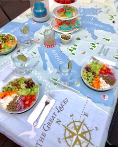 a table topped with plates of food on top of a map