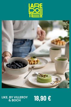 a table topped with plates of food next to cups and saucers on top of it