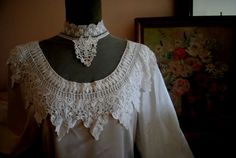 "Victorian style vintage  1990 , off white  glossy polyester blouse  with  french, irish lace, tulle yoke.                                                                                                                                                                                                         Made   By Sonya Ratay for San Andre.  Great design: long  cinched, slouchy sleeve with a cuff. Closure on the back with  a matching color buttons. Rich front  accented with a round tulle yoke a Victorian Blouse With Lace Trim For Wedding, Victorian Cotton Blouse With Lace Collar, Victorian Blouse With Lace Collar, Vintage Lace Trim V-neck Blouse, White Victorian Blouse With Lace Trim, Puff Sleeves Blouse, Forest Green Dresses, Double Breasted Dress, White Cotton Blouse