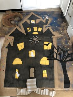 a house painted on the floor with halloween decorations