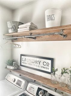 a washer and dryer in a small room with shelves above the washer