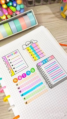 an open notebook with colorful stickers on it next to some markers and pencils