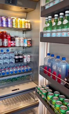 an open refrigerator filled with lots of sodas and water bottles next to each other