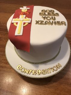 a cake decorated with the colors of red, white and gold on a wooden table