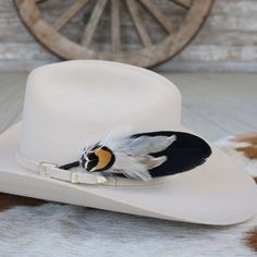 This handmade arrangement of feathers is the perfect way to set your hat apart from the rest. Simply tuck into the band of any hat.  Made with a mix of pheasant, goose, and rooster feathers. Approximately 7 inches long, sizes may vary due to being made with natural materials. Includes: 1 Handmade Arrangement of Feathers. How to use: Tuck into the hat band of any hat. *Each one will vary slightly due to being handmade. *Hat not included. Vintage Feather Hat Bands For Western-themed Events, Vintage Feather Hat Bands For Country Events, Custom Feather Hat Bands For Country Events, Vintage Hat Bands With Feathers For Country Events, Western Hat Bands With Feathers For Rodeo, Southwestern Feather Hat Band For Country Events, Western Style Brimmed Top Hat With Feathers, Western Felt Hat With Feathers For Kentucky Derby, Western Mini Hat With Feathers For Country Events