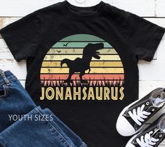 Dinosaur Shirt personalized with child's name. This is the tee that you've been looking for, and it's bound to become a favorite in any youngster's wardrobe. It's light, soft, and comes with a unique design that stands out from the crowd wherever you go! PLEASE CHECK ETSY MESSENGER FOR PROOF 1-24 HOURS AFTER PLACING ORDER. We are not able to add your order to the queue for printing without approval. Thank you PLEASE SEE SIZE CHART (last product photo) BEFORE ORDERING as we are not able to offer Dinosaur Shirt Kids, Dinosaur Shirts, Dino Shirt, Dinosaur Shirt, Baby Dinosaurs, Matching Outfit, Dinosaur Kids, Dinosaur Birthday, 3 Kids