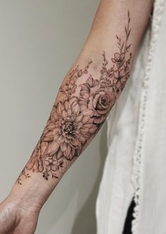 a woman's arm with flowers on it