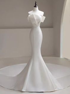 a white dress on a mannequin in a room