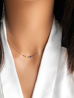 This delicate rainbow necklace is made with tiny colorful beads strung on a thin silver plated necklace. A simple minimalist necklace that can be worn alone or layered. - Silver plated - Tiny beads - Jewelry is packaged in box and ready to gift - Ships in 1-2 days! Available in sterling silver in our sister store https://www.etsy.com/listing/1072152865/sterling-silver-rainbow-necklace-silver?ref=shop_home_recs_15 Also available in plated gold: https://www.etsy.com/listing/943577809/rainbow-neckl Pride Necklace, Necklace Colorful, Rainbow Necklace, Rainbow Beads, Hand Stamped Jewelry, Silver Plated Necklace, Silver Plated Jewelry, Bead Stringing, Colourful Necklace