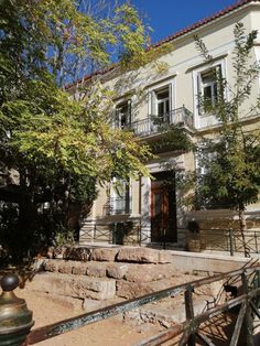 an old house with stone steps leading up to it