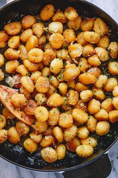 a skillet filled with potatoes and garnished with parsley