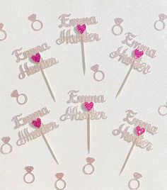 wedding cake toppers with pink hearts and names on white frosted tablecloths