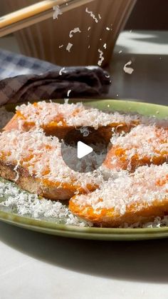 a plate topped with donuts covered in sugar and sprinkled with powdered sugar