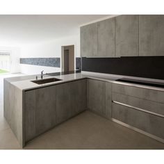 a modern kitchen with an island counter and sink