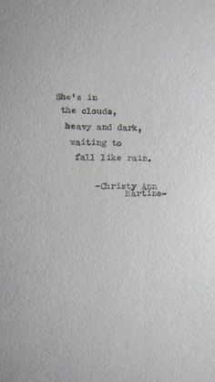 an old typewriter with the words, she's in clouds and dark, waiting for