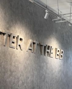 there is a sign that says river at the bb on the wall in front of it