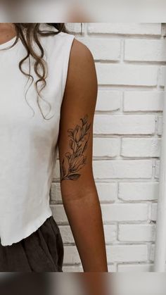 a woman with a tattoo on her arm