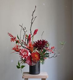 a vase filled with flowers sitting on top of a wooden table