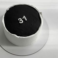 a black and white photo of a cake with the number eight on it's side