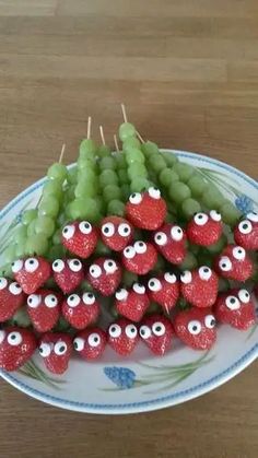 grapes and strawberries are arranged in the shape of eyeballs on a platter