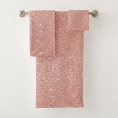 pink glitter towels hanging on a towel rack