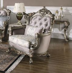 an ornately decorated living room with two chairs and a rug in front of it