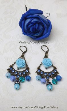 Light Blue Chandelier Earrings, Blue Bohemian Earrings, Boho Artistic Earrings, Chandelier Bohemian Earrings A bohemian pair of light  blue chandelier  earrings !!!Features light  blue tiny rhinestones ,  Czech crystal beads , antique bronze findings  , light blue resin  rose beads and antique bronze lever backs .The most  interesting , joyful, impressive, artistic and light BLUE earrings !!!! Measures approx. 2.50  " - 7 cm in length. 🌹Select  from VintageRoseGallery as many items as you like Vintage Turquoise Dangle Flower Earrings, Handmade Bohemian Blue Chandelier Earrings, Blue Bohemian Dangle Earrings, Bohemian Blue Earrings For Party, Artistic Blue Party Earrings, Blue Bohemian Earrings For Pierced Ears, Bohemian Blue Chandelier Earrings As Gift, Bohemian Blue Teardrop Flower Earrings, Blue Bohemian Chandelier Earrings