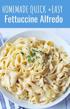 a white bowl filled with fettuccine alfredo on top of a blue and white towel