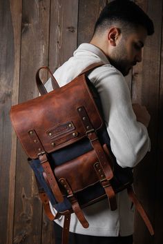 a man wearing a brown leather backpack