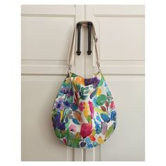 "This colorful hobo bag, thanks to being a fabric bag, is very light while using but it is sturdy enough to carry all your daily necessities.  The hobo bag has an adjustable and removable strap made of cotton webbing in color natural. Details:  * Watercolor Design printed polyester fabric  * Fully lined with 100% cotton fabric in natural color * Inside two pockets, one is open ( 23x18 cm/ 9x7\" ) one is zippered ( 23x20 cm/ 9x8\" ) * Removable and adjustable natural color cotton handle can be adjusted in length from 65 cm to 112 cm ( 25,59\" to 44\" ) with hooks. * One magnetic snap button for clousure * Silver color hardware Approx. dimensions of this bohemian shoulder bag are: Height- Width- Depth : 39x39x6 cm / 15,35x15,35x2,36\" Due to different computer screen features, there might be Daily Necessities, Fabric Bag, Everyday Bag, Watercolor Design, Hobo Bag, Silver Color, Purses And Handbags, Polyester Fabric, Mother's Day Gifts