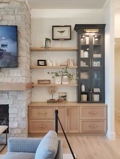 a living room filled with furniture and a flat screen tv mounted on the wall above a fireplace