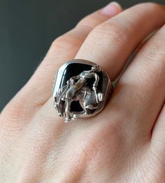 "* Vintage mid-century western handmade sterling silver ring, set with a black glass cabochon, and a cowboy riding a bucking bronc. * Stamped \"Sterling\" on the inside of the band  * Face of the ring measures at 0.9 inch long x 0.75 inch wide  * Weight- 15.5 grams  Please view and inspect the photos closely, as they are considered part of the condition. I endeavor to fully disclose all condition information clearly, however, please note that what qualifies as excellent condition for historical jewelry / collectibles differs from modern and contemporary pieces. Minor age wear is typical and to be expected for antique and vintage jewelry. All items are unpolished and in their vintage condition, items can easily be polished up if so desired.     Enjoy,  Dev" Vintage Black Jewelry For Western-themed Events, Western Engraved Jewelry For Rodeo, Western Style Engraved Jewelry For Rodeo, Western Black Jewelry For Rodeo, Black Western Style Jewelry For Rodeo, Formal Sterling Silver Jewelry With Horse Design, Black Engraved Western Jewelry, Black Concho Jewelry For Western-themed Events, Handmade Western Silver Rings