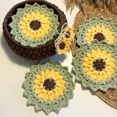 two crocheted sunflower coasters sitting next to each other