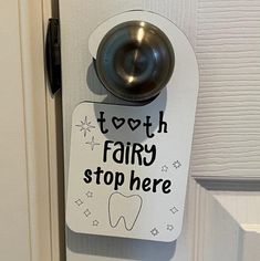 a door handle that says tooth fairy stop here